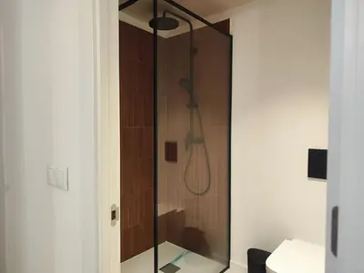 a shower with a glass door in a bathroom at Mazi Plaça Gran in Mataró