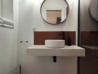 a bathroom with a sink and a mirror at Mazi Plaça Gran in Mataró