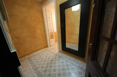 an empty hallway with a door and a tile floor at Plaza España Central Apartment in Barcelona