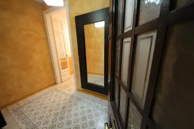 a hallway with a door and a tile floor at Plaza España Central Apartment in Barcelona