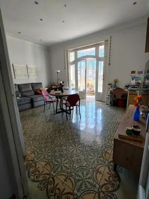 a living room with a couch and a table at Pis històric modernista al centre de Manresa in Manresa
