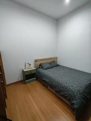 a bedroom with a bed and a night stand at Pis històric modernista al centre de Manresa in Manresa
