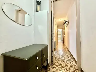 a bathroom with a vanity and a mirror and a hallway at Bright 3 Bedroom Apartment Central Barcelona in Barcelona