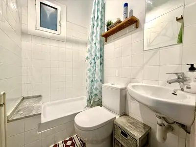 a bathroom with a toilet and a sink at Bright 3 Bedroom Apartment Central Barcelona in Barcelona