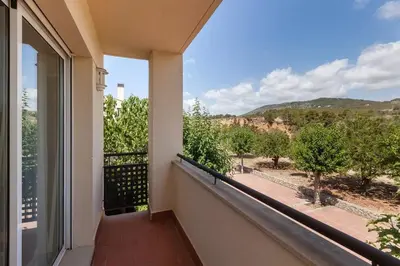 a balcony with a view of the mountains at La Cantonada in Sant Pere de Ribes