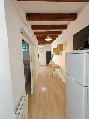 a kitchen and dining room with a refrigerator and a table at Elegant apartment Sagrada Familia in Barcelona