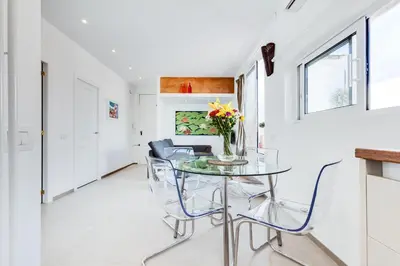 a dining room with a glass table and chairs at St. Antoni sky lounge in Barcelona