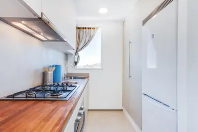 a kitchen with white walls and a stove top oven at St. Antoni sky lounge in Barcelona