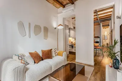 a living room with a white couch and a glass table at Amplio Apartamento en Barcelona in Barcelona