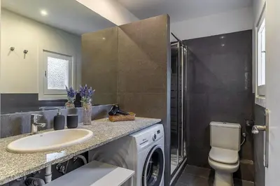 a bathroom with a sink and a washing machine at 4329 - AB Eixample Centric in Barcelona