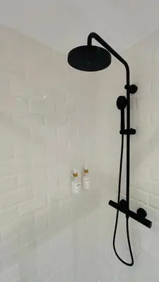 a shower with a black light in a bathroom at Bajos con encanto by Prestigi in Terrassa