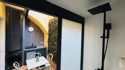 a kitchen with a white table and a stove at Bajos con encanto by Prestigi in Terrassa
