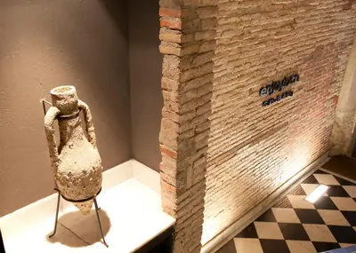 a statue of a woman on a table next to a brick wall at Enjoybcn Colon Apartments in Barcelona