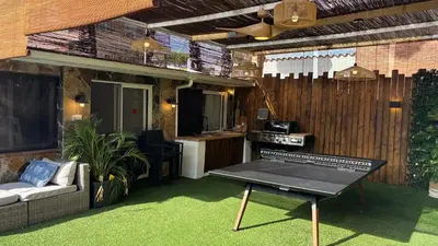 a patio with a table in front of a house at Loue Villa à Castelldefels BARCELONE avec piscine, 8 couchages, 7 minutes de la plage in Castelldefels