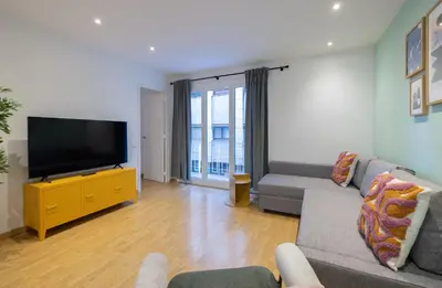 a living room with a couch and a flat screen tv at Stay U-nique Apartment Castanyer II in Barcelona