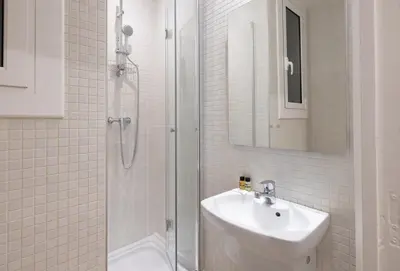a white bathroom with a shower and a sink at Stay U-nique Apartment Castanyer II in Barcelona