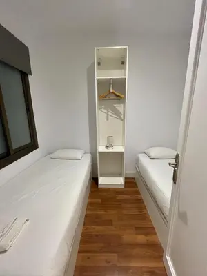 a small room with two beds and a closet at Practical, 3 double bedrooms, 7' Sagrada Familia in Barcelona