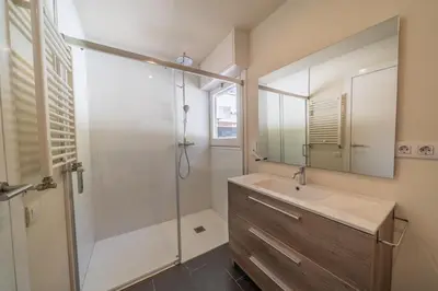 a bathroom with a sink and a shower with a mirror at Casanova, villa with Barcelona's skyline in Cabrils