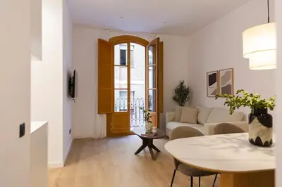 a living room with a table and a couch at Barcelona - Gracia P-A in Barcelona