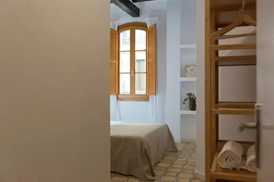 a bedroom with a bed and a window at Barcelona - Gracia 1-A in Barcelona