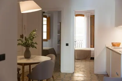 a kitchen and dining room with a table and chairs at Barcelona - Gracia 1-A in Barcelona
