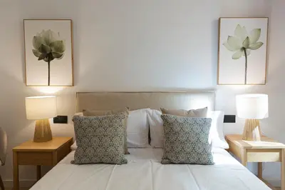 a bedroom with two lamps and a white bed at Barcelona - Gracia 1-A in Barcelona