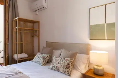 a bedroom with a bed with pillows and a lamp at Barcelona - Gracia 2-A in Barcelona