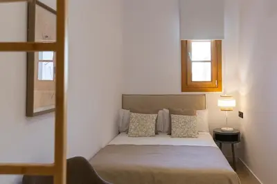 a bedroom with a bed and a window and a ladder at Barcelona - Gracia 2-A in Barcelona