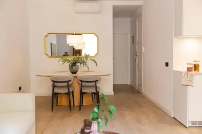 a dining room table with chairs and a mirror at Barcelona - Gracia 2-A in Barcelona