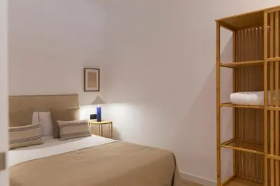 a bedroom with a bed and a book shelf at Barcelona - Gracia 2-B in Barcelona