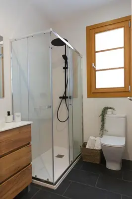 a bathroom with a shower with a toilet and a window at Barcelona - Gracia 2-B in Barcelona