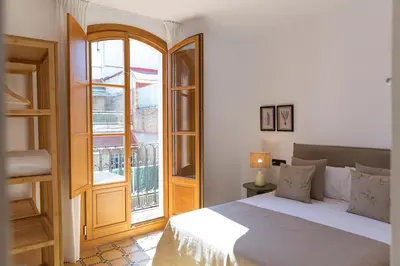 a bedroom with a bed and a large window at Barcelona - Gracia 4-A in Barcelona