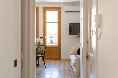 a hallway with a door and a couch and a chair at Barcelona - Gracia 4-A in Barcelona