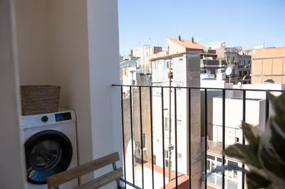 a balcony with a washing machine and a view of a city at Barcelona - Gracia 4-A in Barcelona