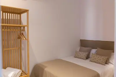 a small bedroom with a bed with a shelf at Barcelona - Gracia 4-B in Barcelona