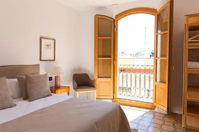 a bedroom with a bed and a large window at Barcelona - Gracia 4-B in Barcelona
