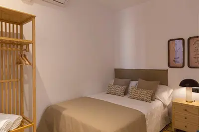 a bedroom with a bed and a mirror at Barcelona - Gracia 4-B in Barcelona