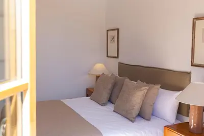 a bedroom with a bed with white sheets and pillows at Barcelona - Gracia 4-B in Barcelona