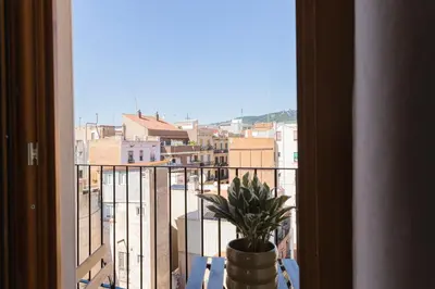 a view of a city from a window with a potted plant at Barcelona - Gracia 5-A in Barcelona