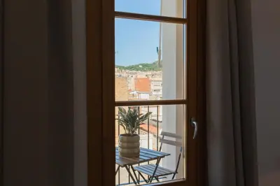 a window with a table and a potted plant at Barcelona - Gracia 5-A in Barcelona