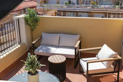 a balcony with a couch and a table and chairs at Barcelona - Gracia 5-A in Barcelona
