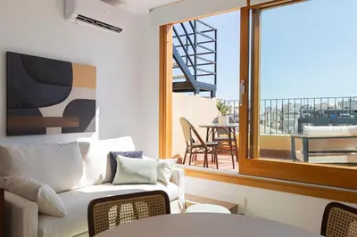a living room with a couch and a balcony at Barcelona - Gracia 5-A in Barcelona
