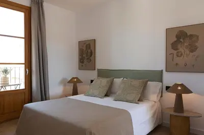a bedroom with a bed with two lamps and a window at Barcelona - Gracia 5-A in Barcelona
