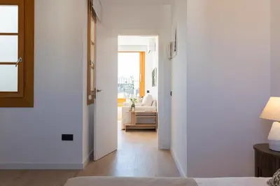 a bedroom with a door open to a living room at Barcelona - Gracia 5-B in Barcelona