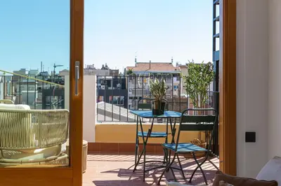 a balcony with a table and chairs on a balcony at Barcelona - Gracia 5-B in Barcelona