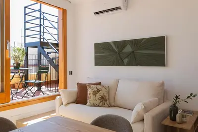a living room with a couch and a window at Barcelona - Gracia 5-B in Barcelona