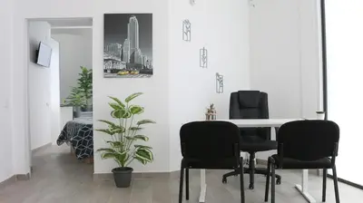 a dining room with black chairs and a table at Entire apartment, accessible ground floor in Hospitalet de Llobregat