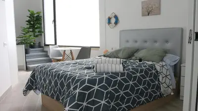 a small room with a bed and a table and chairs at Entire apartment, accessible ground floor in Hospitalet de Llobregat