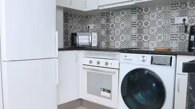 a laundry room with a washer and dryer at Entire apartment, accessible ground floor in Hospitalet de Llobregat