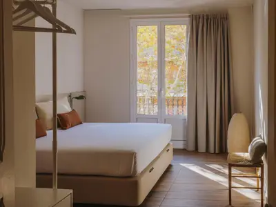 a living room with a couch and a tv at Casa Flor Boutique Mid-term Monthly Rentals in Barcelona